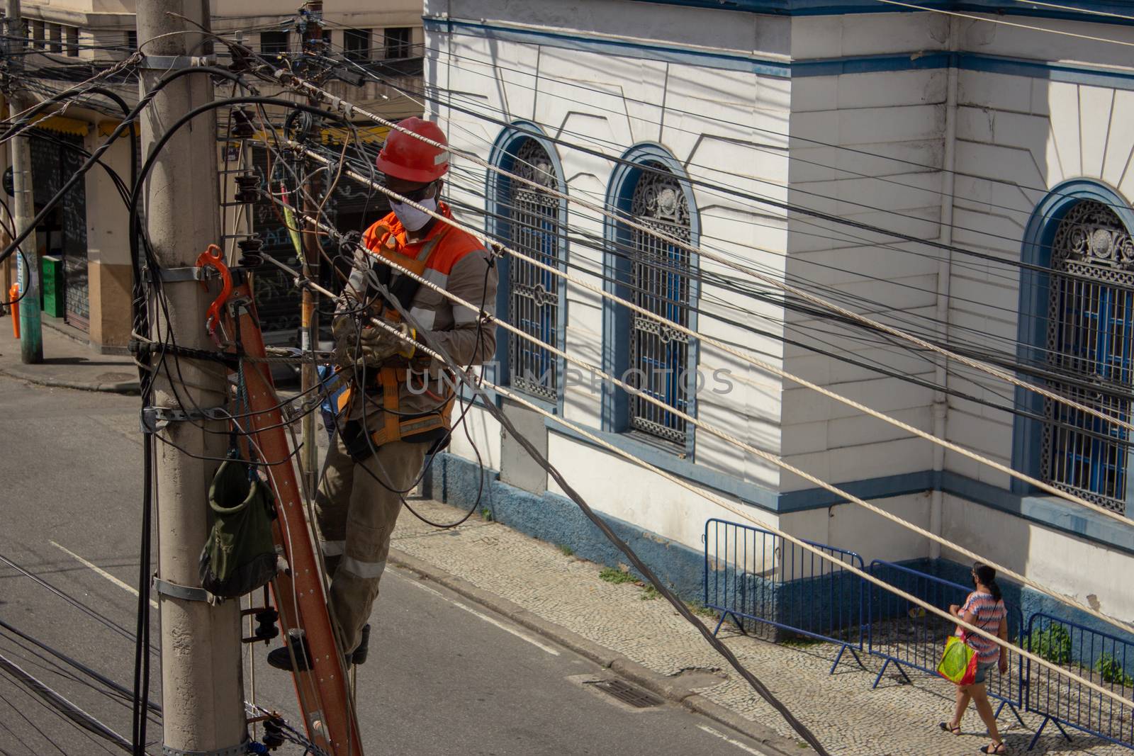 Men repairing electrical grid wires using masks because of COVID-19