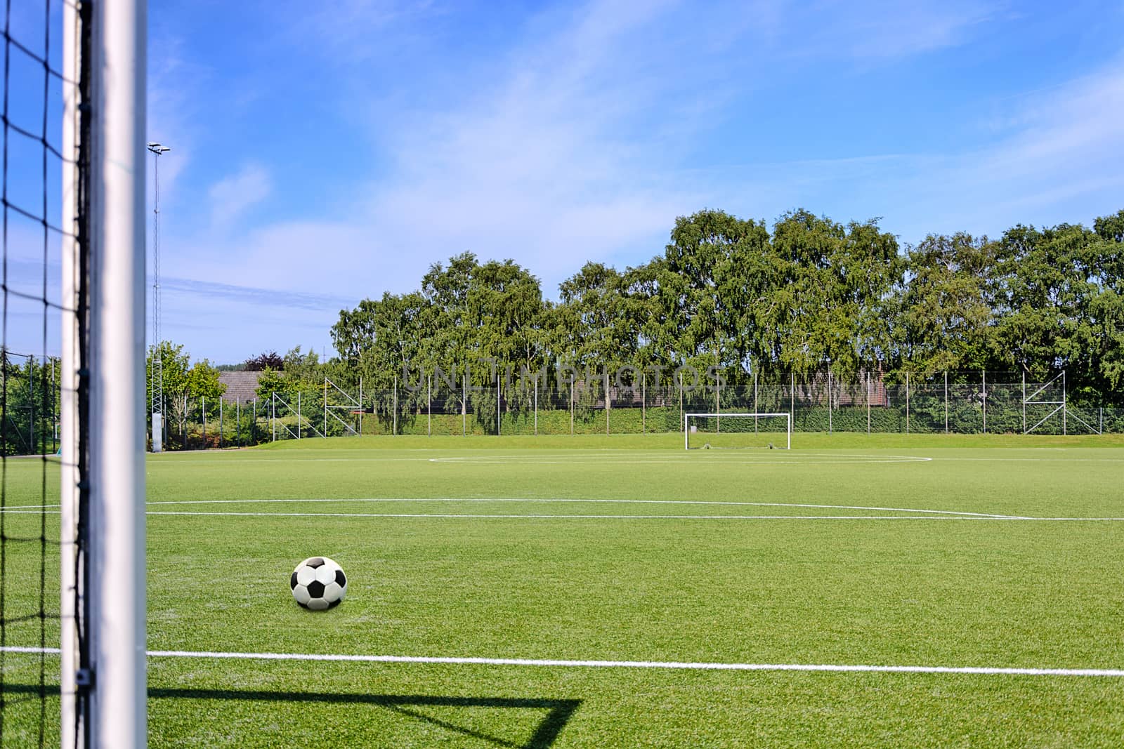 Composite image of a generic school football court on the blue sky background