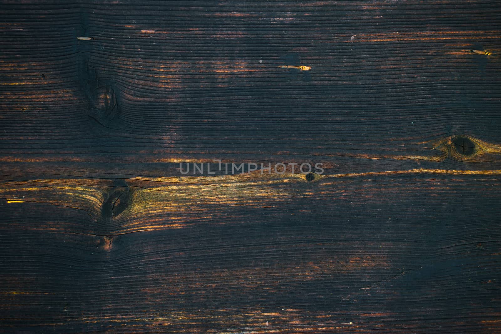 Old and archival dark brown wooden plank as a vintage background.