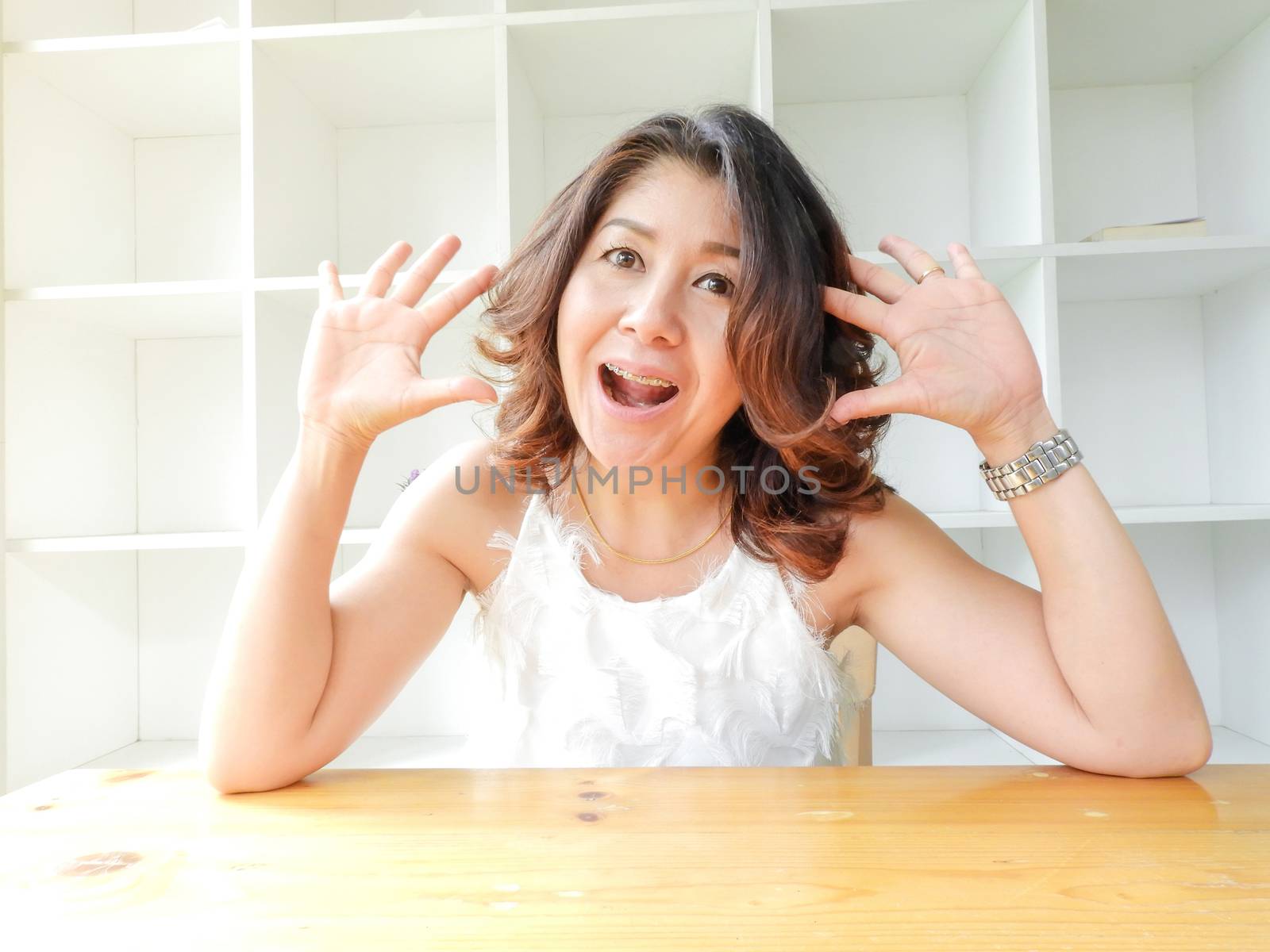 Beautiful woman smiling happy against white background.
