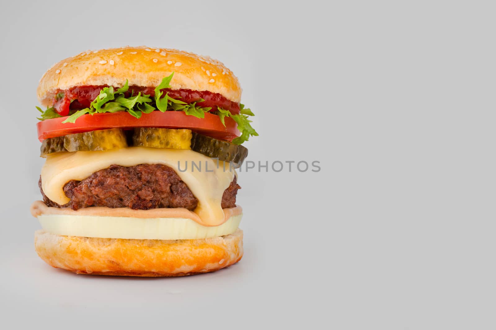 One big tall classic hamburger burger cheeseburger isolated on gray background with copy space