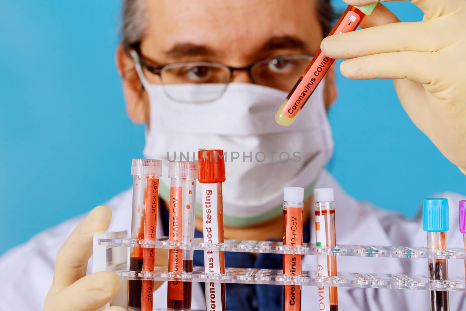 Test tubes filled with blood in check COVID-19 coronavirus laboratory Doctor in face mask