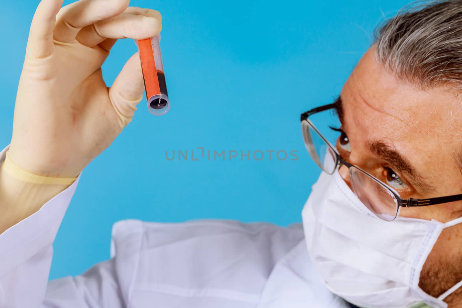 Scientist doctor holding test tube with blood sample in laboratory