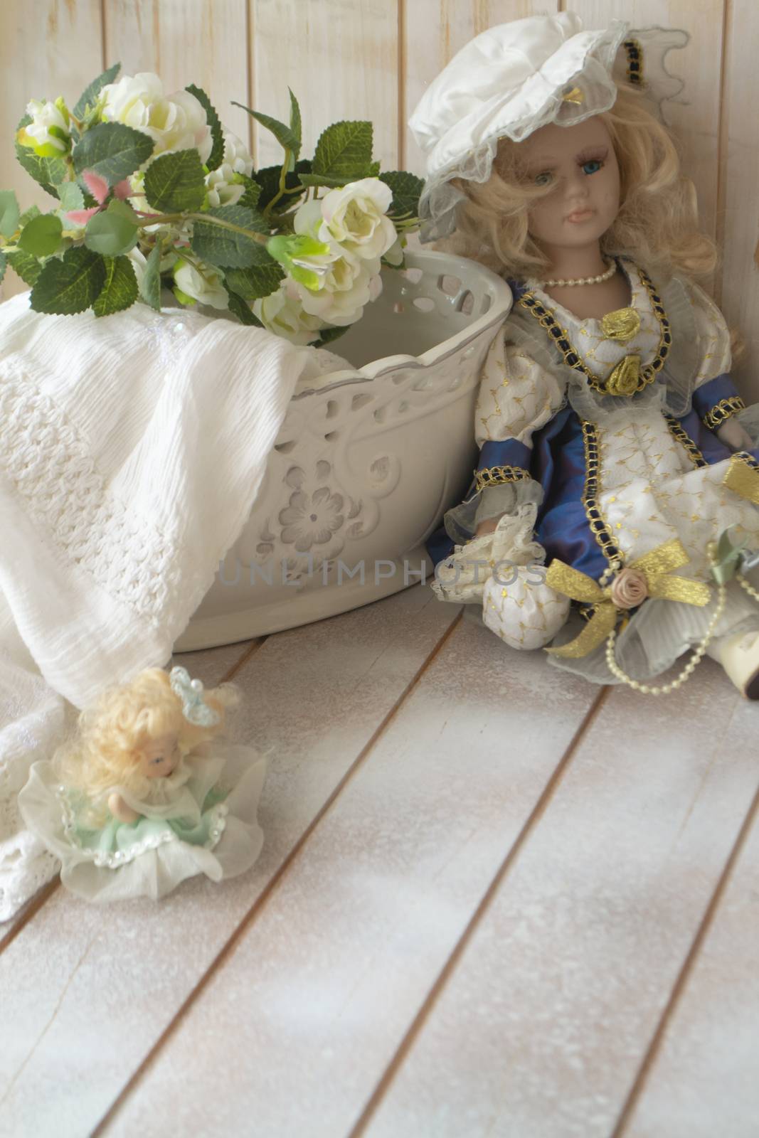 vintage porcelain doll in the shabby table. Porcelain doll in vintage interior.
