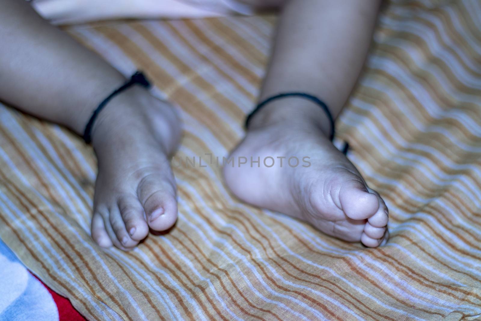 Cute baby feet, cute baby playing on blanket