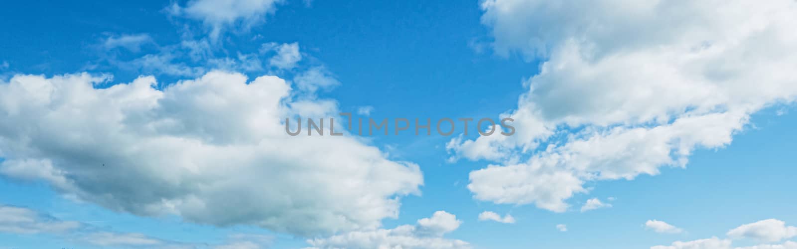 Bright blue sky with clouds, nature and environment by Anneleven