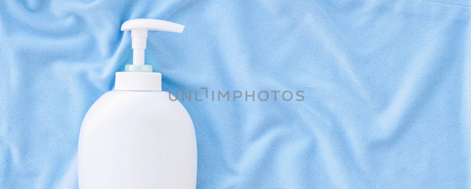 Blank label bottle of antibacterial liquid soap and hand sanitizer mockup on blue silk, hygiene product and health care, flatlay