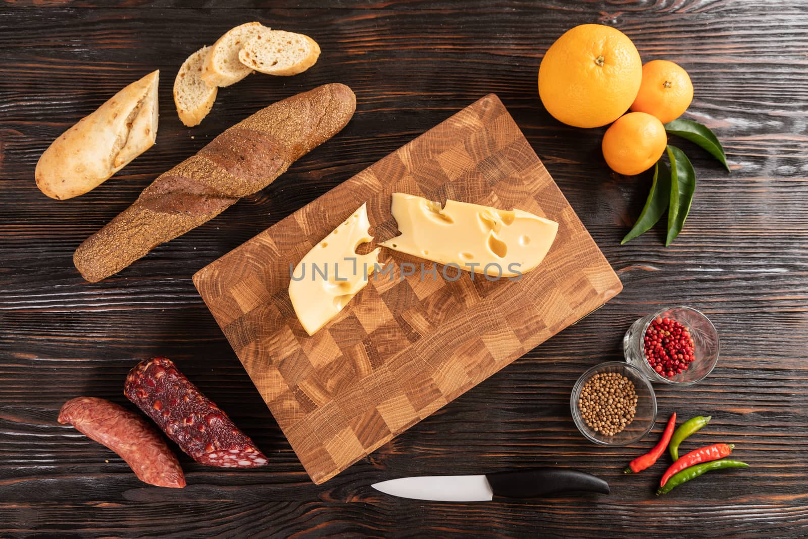 Sausage, cheese and bread on cutting board by sveter