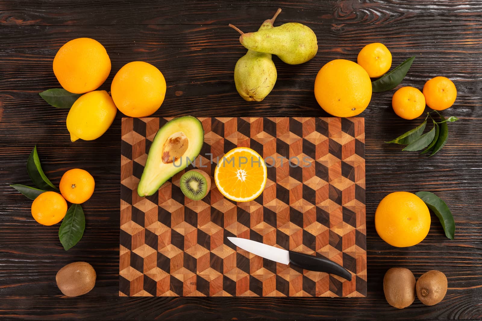Fruit with knife on wooden cutting board by sveter