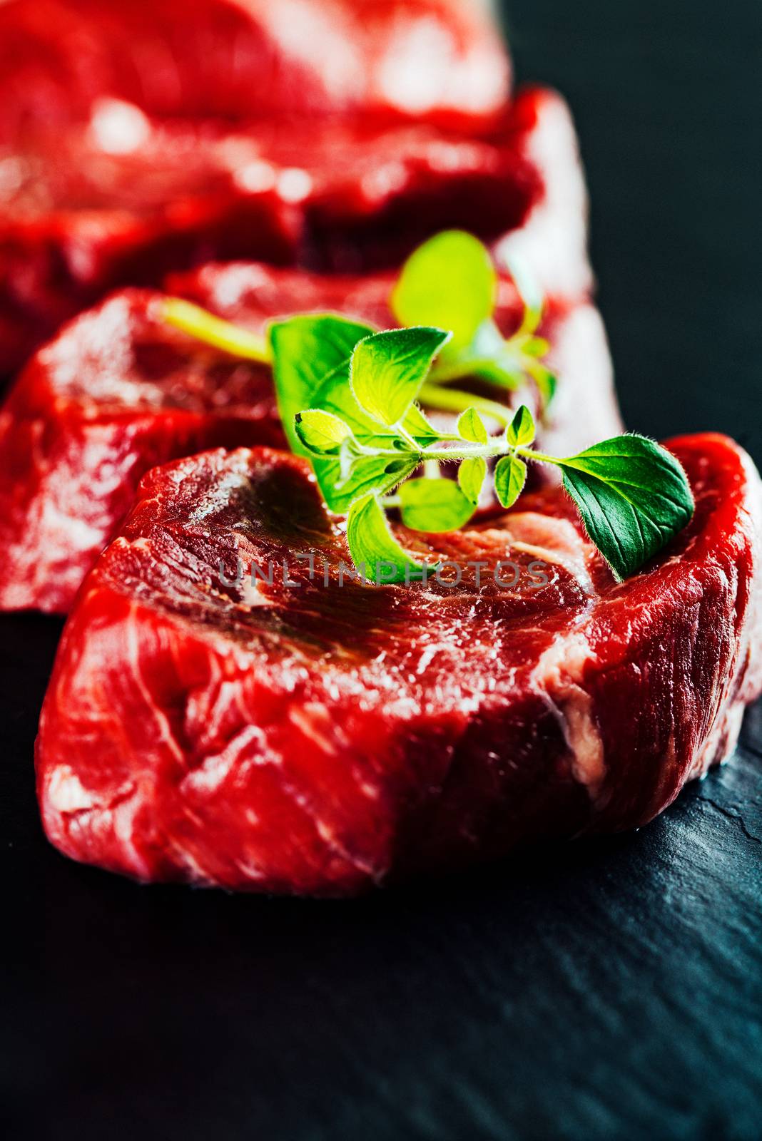 Beef steaks on cutting board close up