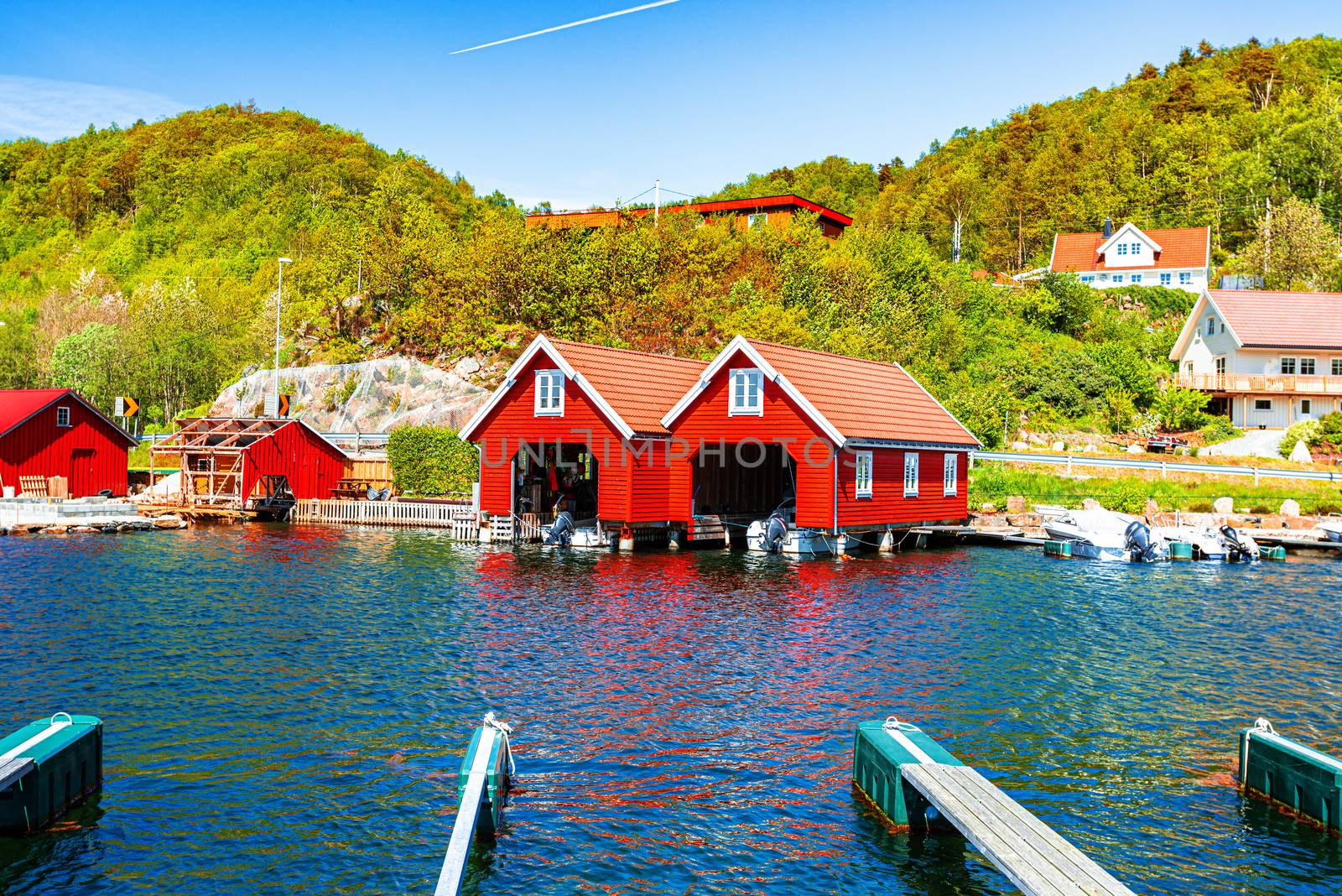 Red and orange houses for keeping boats in Norway