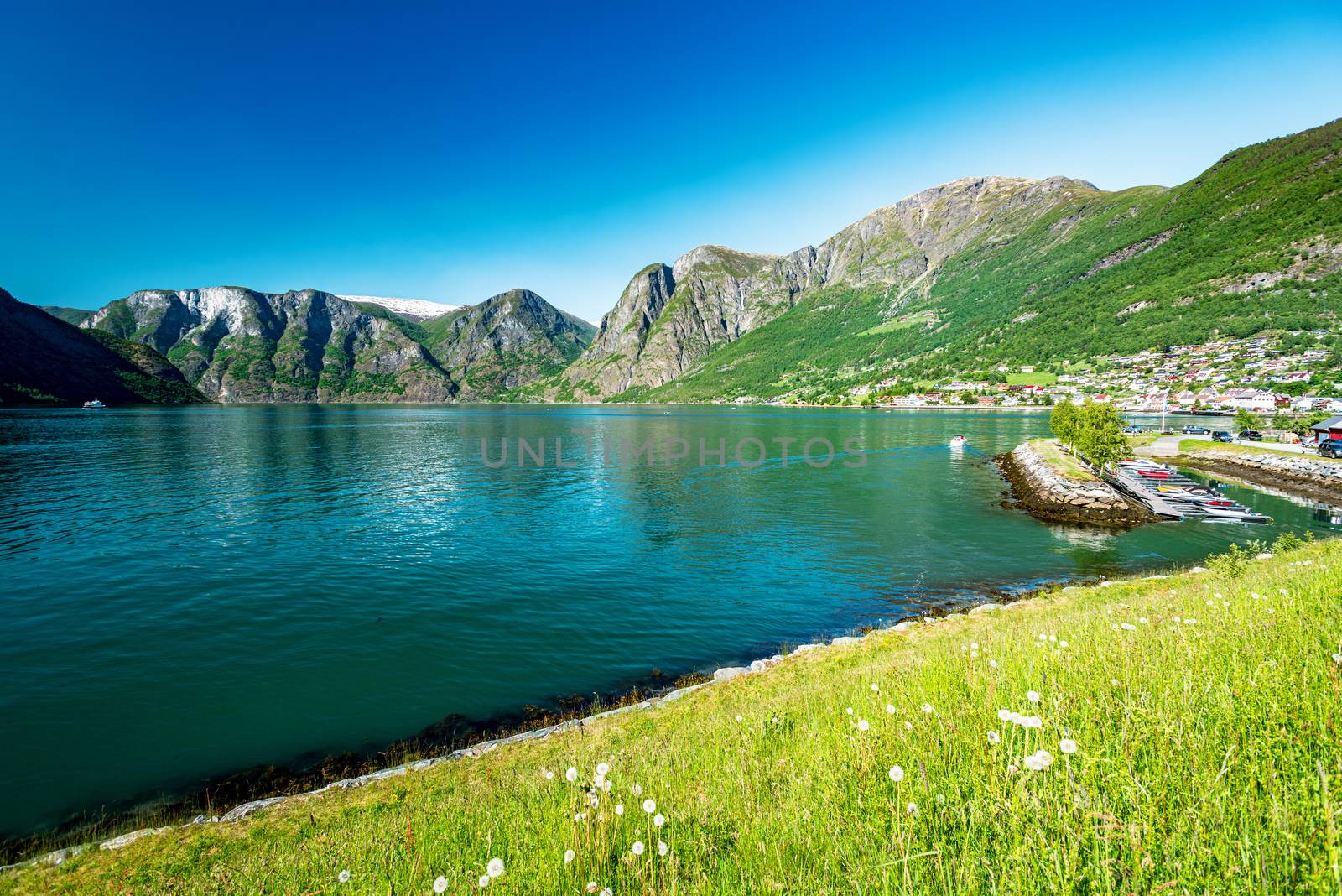 View on a water at summer sunny day, blue sky, boats, mountain