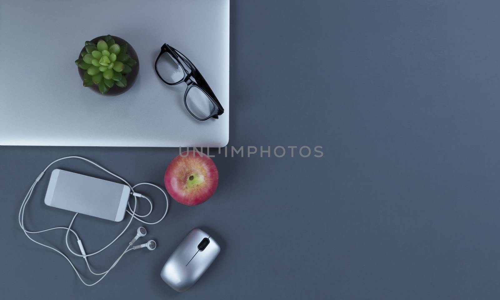 Teleworking grey desktop with mobile devices in flat lay format by tab1962