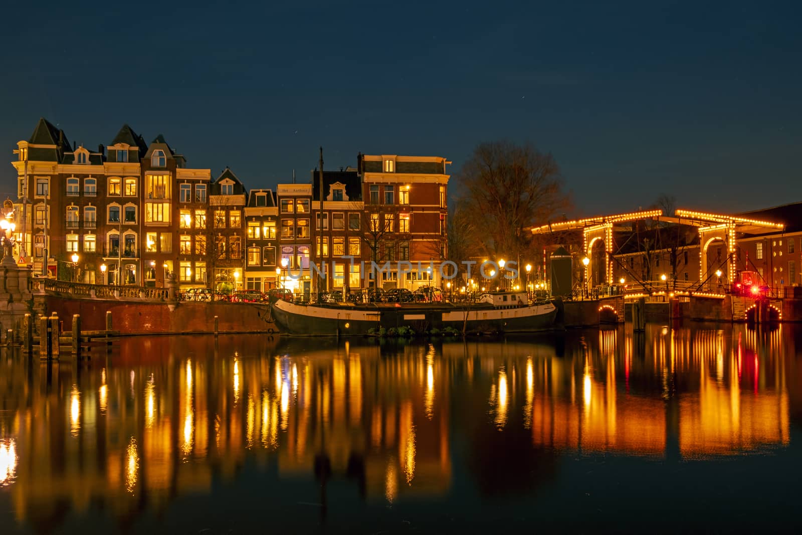 City scenic from Amsterdam at the river Amstel  in the Netherlands at night