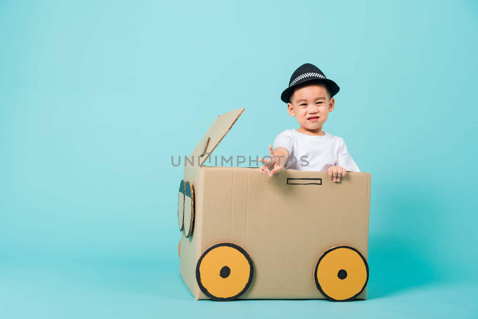 Baby children boy smile in driving play car creative by a cardbo by Sorapop