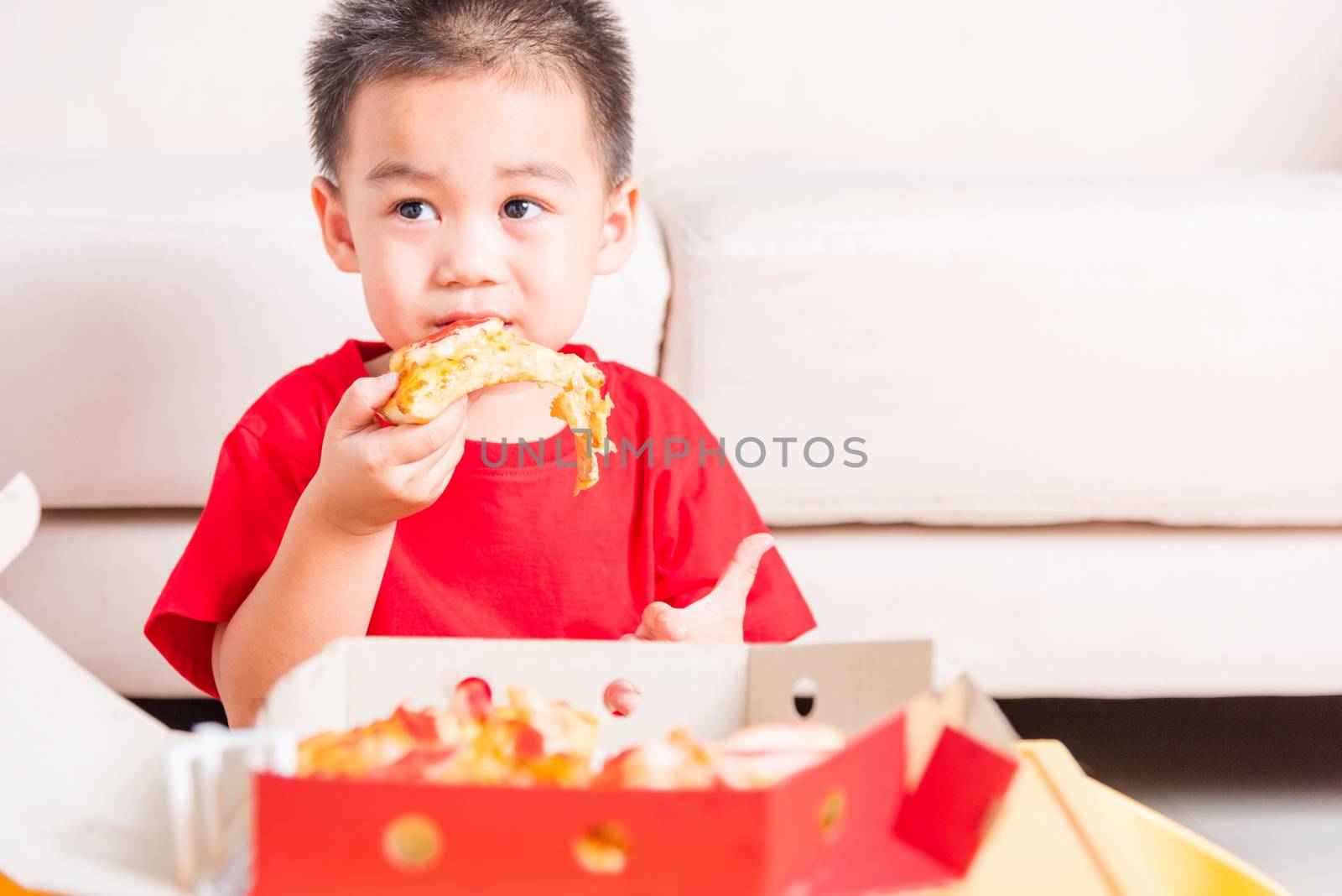 Hot Homemade, Vegetarian fast Italian food, Cute Little Child enjoying eating Delivery Pizza pepperoni, cheese many slices deliciously in an open cardboard box at home