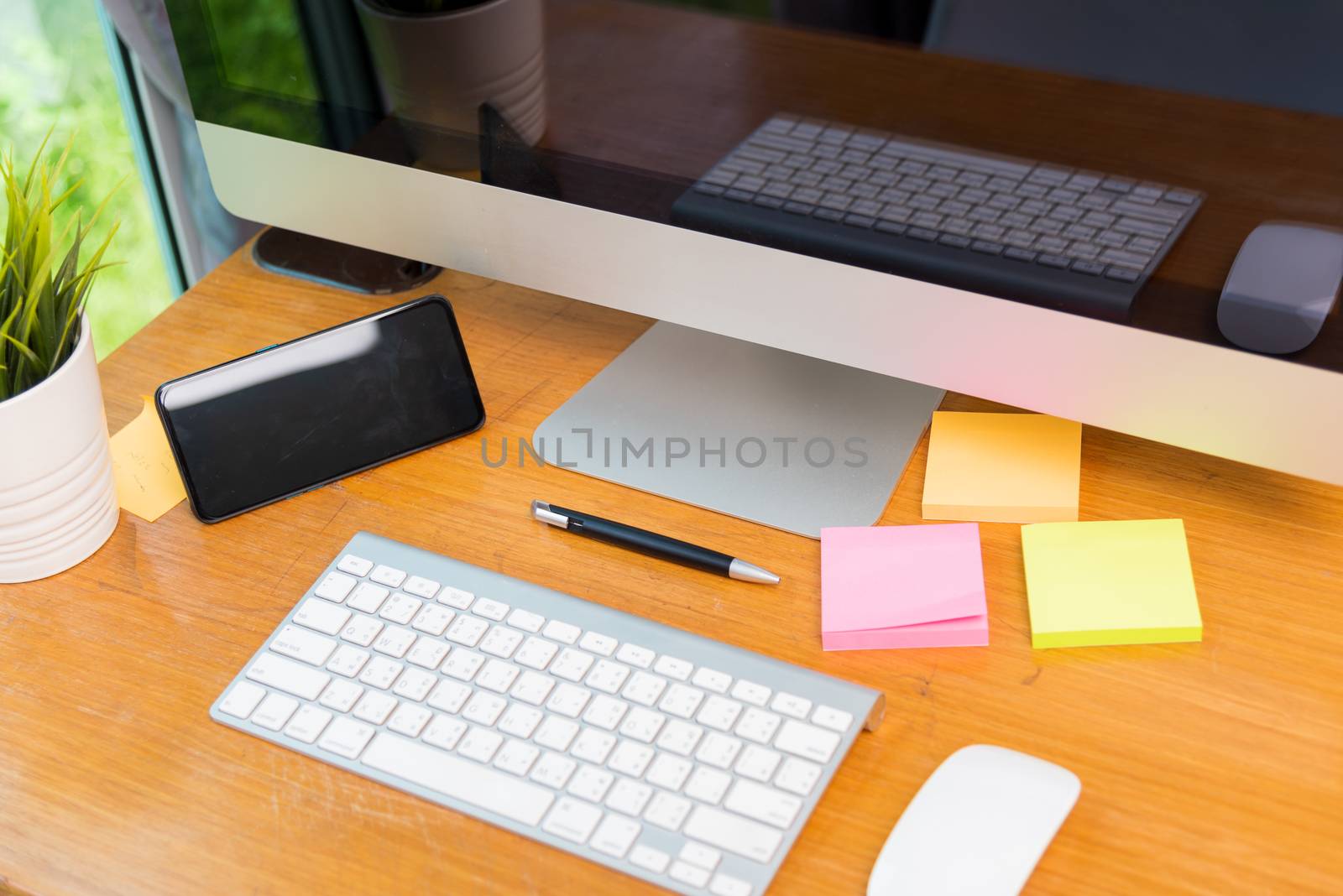 Home office interior blank screen desktop PC computer and smart phone decorations on desk under curfew quarantine pandemic coronavirus COVID-19