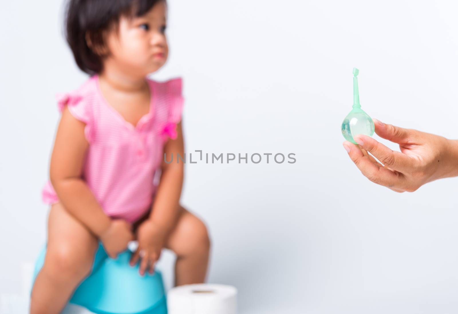 baby child girl training to sitting on blue chamber pot or potty by Sorapop