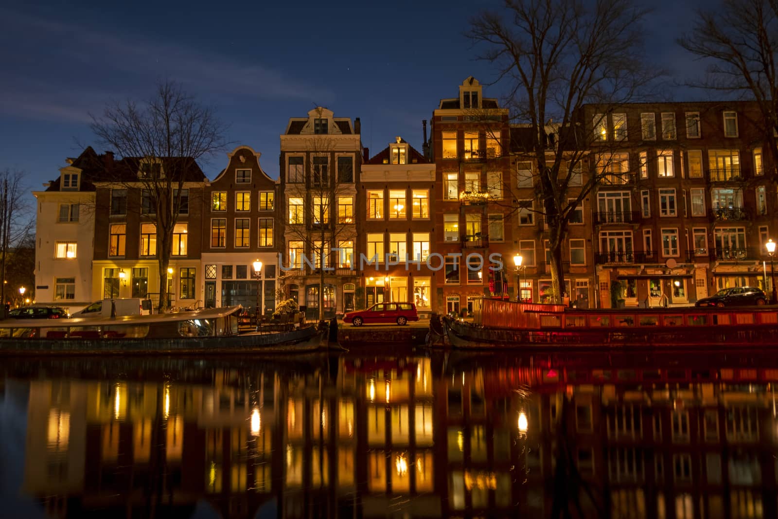 City scenic from Amsterdam at the Amstel in the Netherlands at night