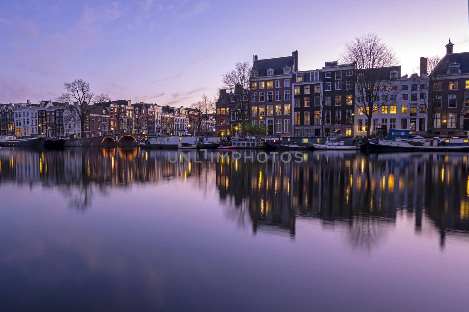 City scenic from Amsterdam  at the Amstel in the Netherlands at sunset