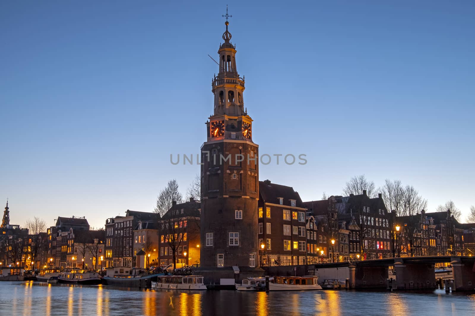 City scenic from Amsterdam with the Montelbaan Tower in the Netherlands at sunset