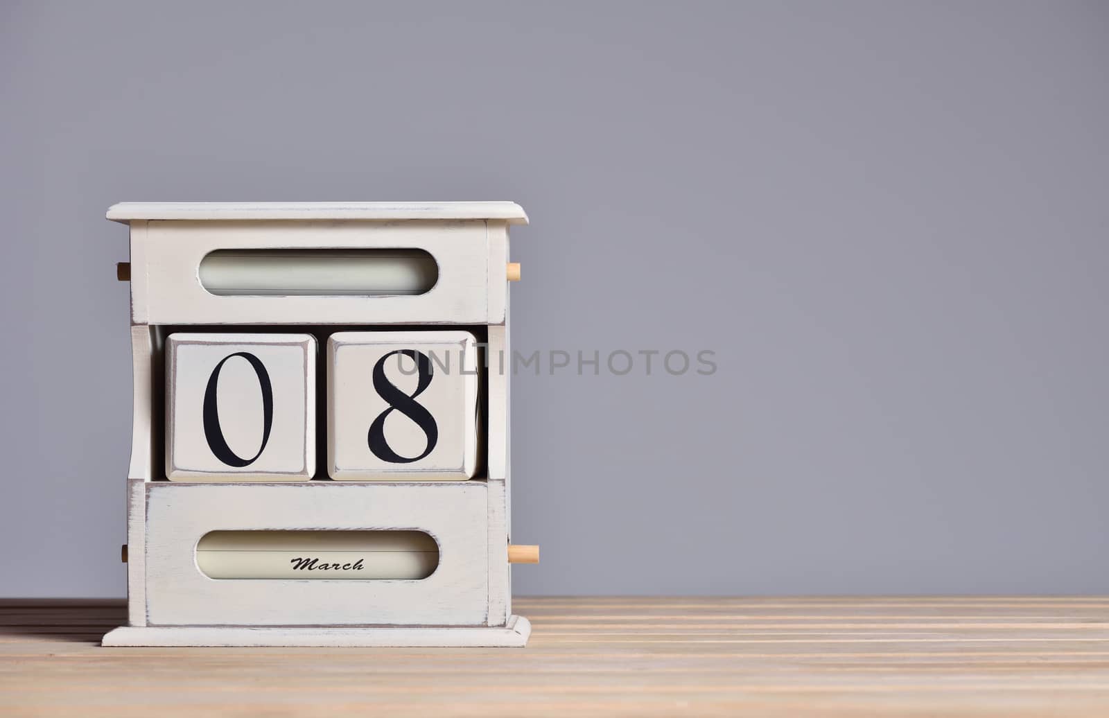 Retro calendar with the date March 8, International Women's Day and free text space on a gray wall background.