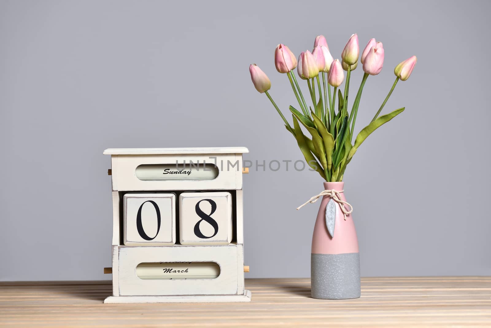 Retro calendar with the date of March 8 and tulips in a vase, International Women's Day and free text space on a gray wall background.