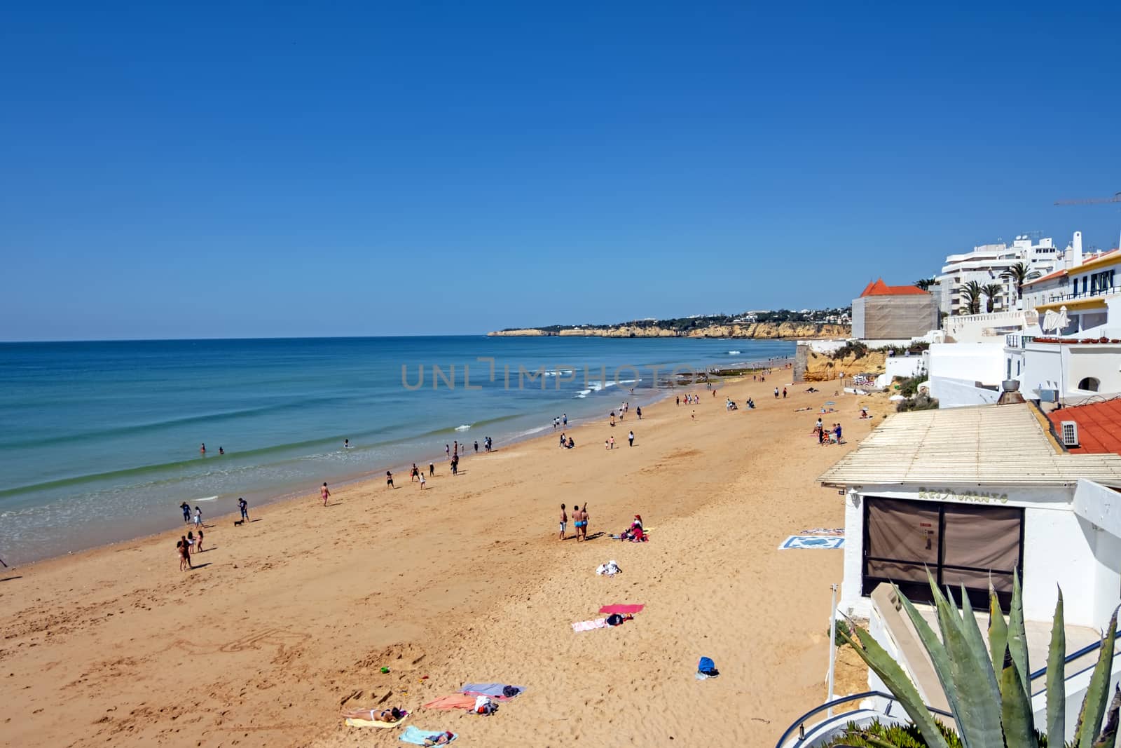 Armacao de Pera, Portugal - April 21, 2019: People enjoying at the beach in Armacao de Pera in the Algarve Portugal