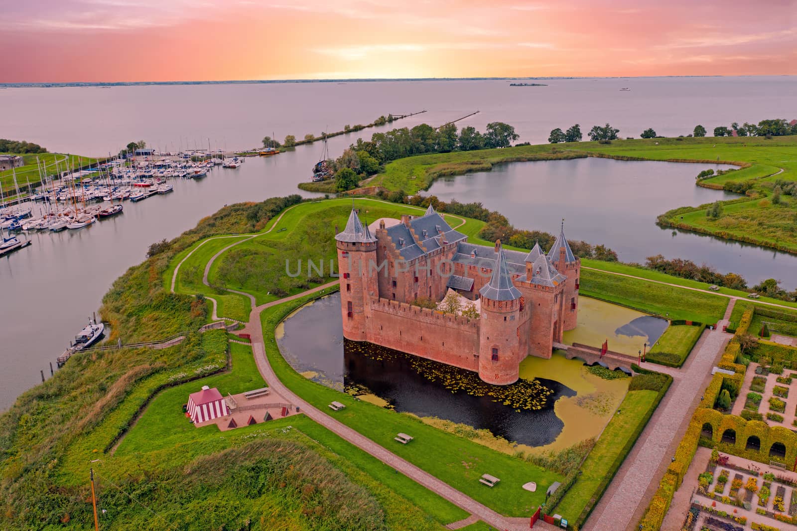 Aerial from medieval castle 'Muiderslot' in the countryside from the Netherlands at sunset