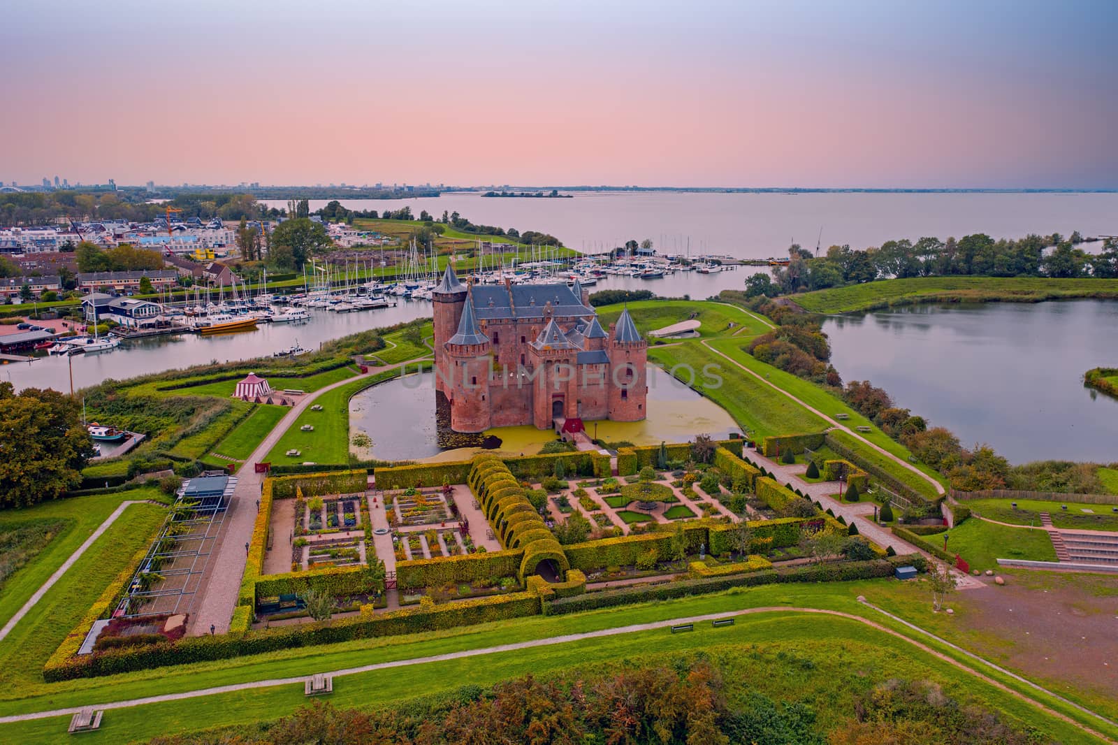 Aerial from medieval castle 'Muiderslot' in the countryside from the Netherlands at sunset