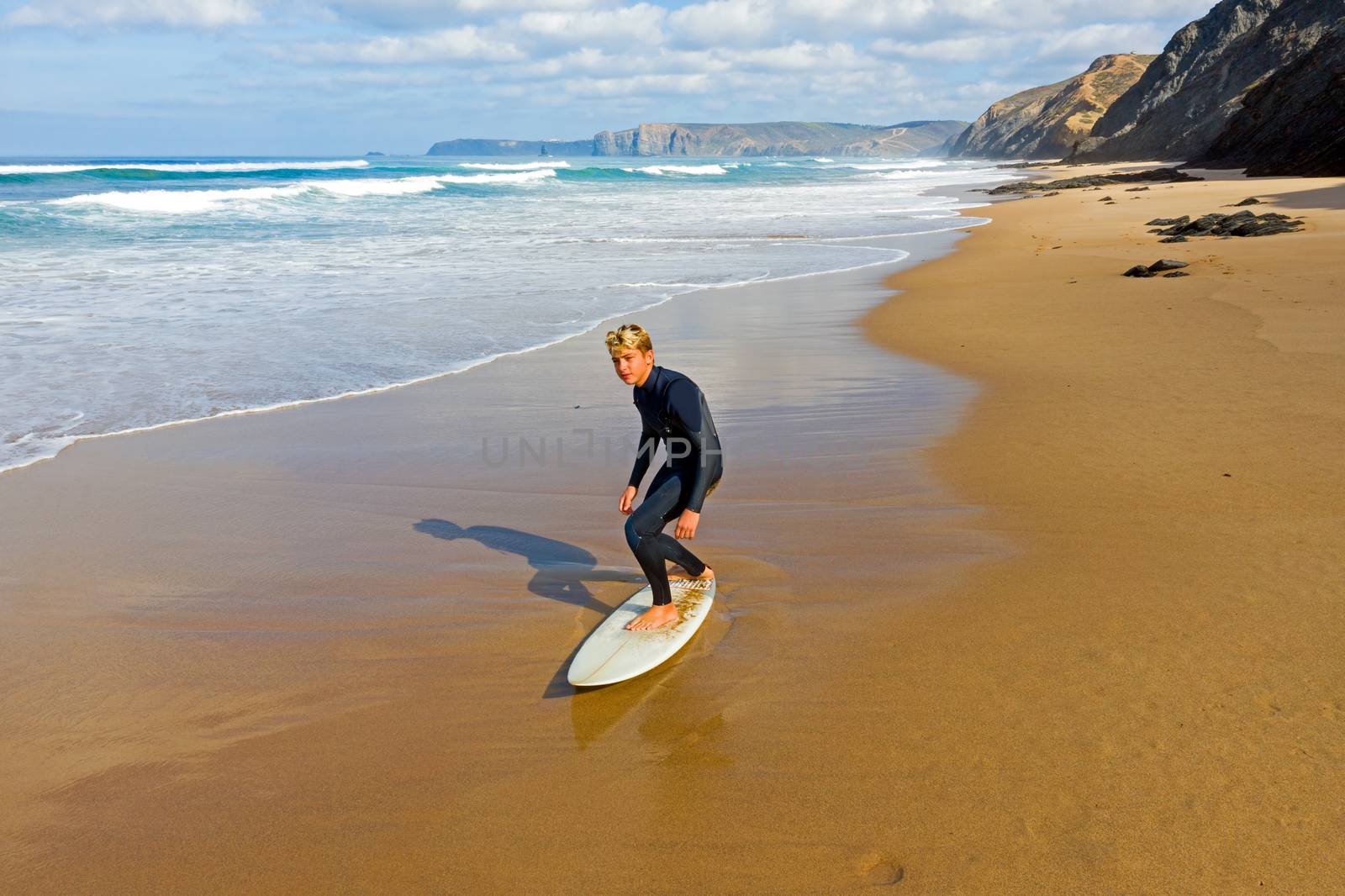 Aerial from a young surfer ready to surf at the atlantic ocean