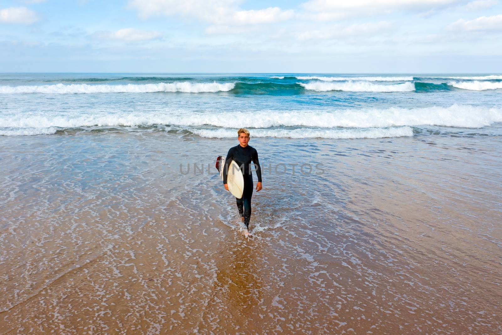 Aerial from a young surfer ready to surf at the atlantic ocean by devy