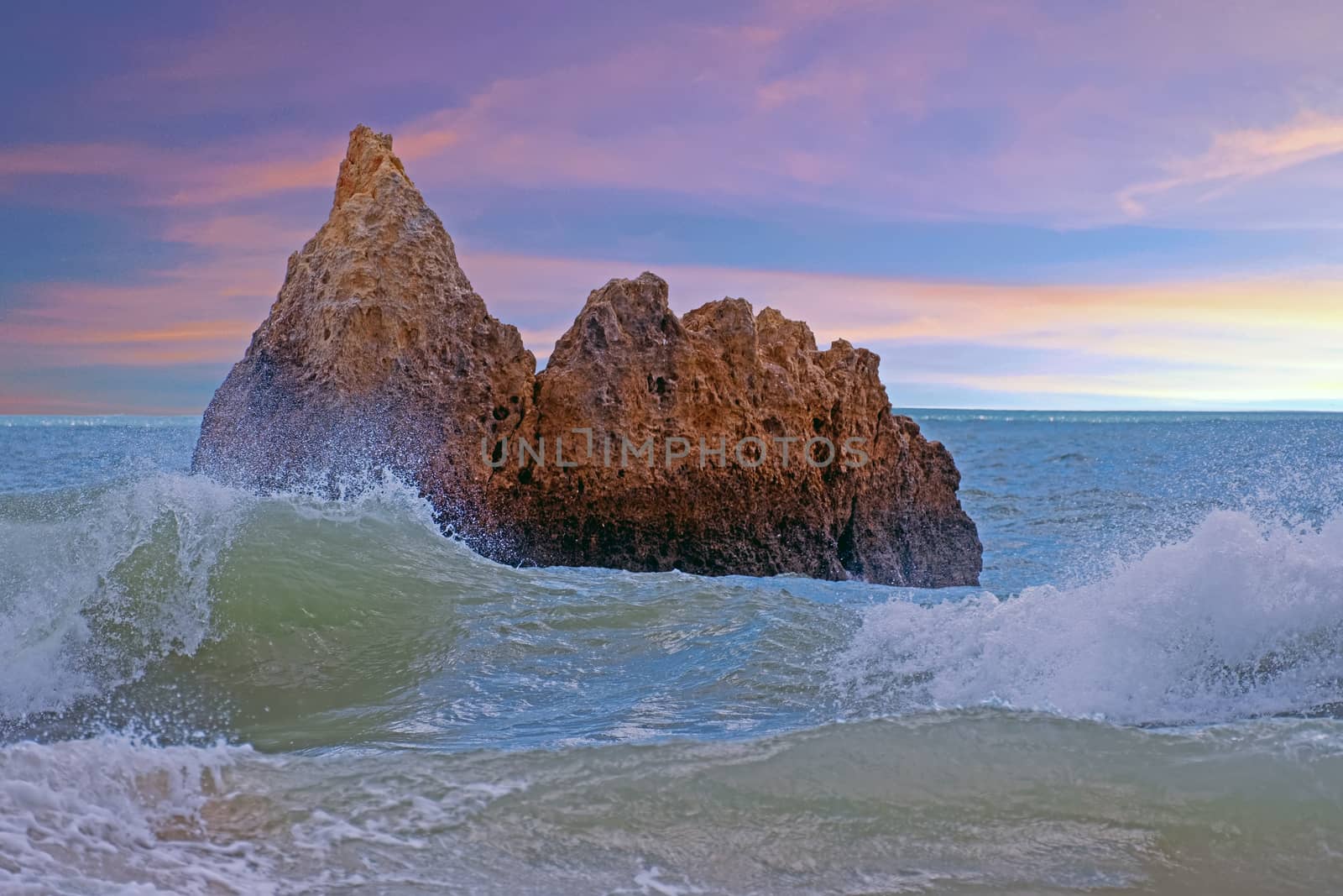 Natural rocks at praia Tres Irmaos in Alvor Algarve Portugal at sunset