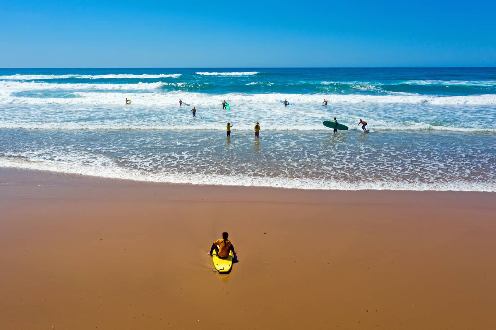 Vale Figueiras, Portugal - 25th may 2019: Aerial from surfers getting surfing lessons in the ocean