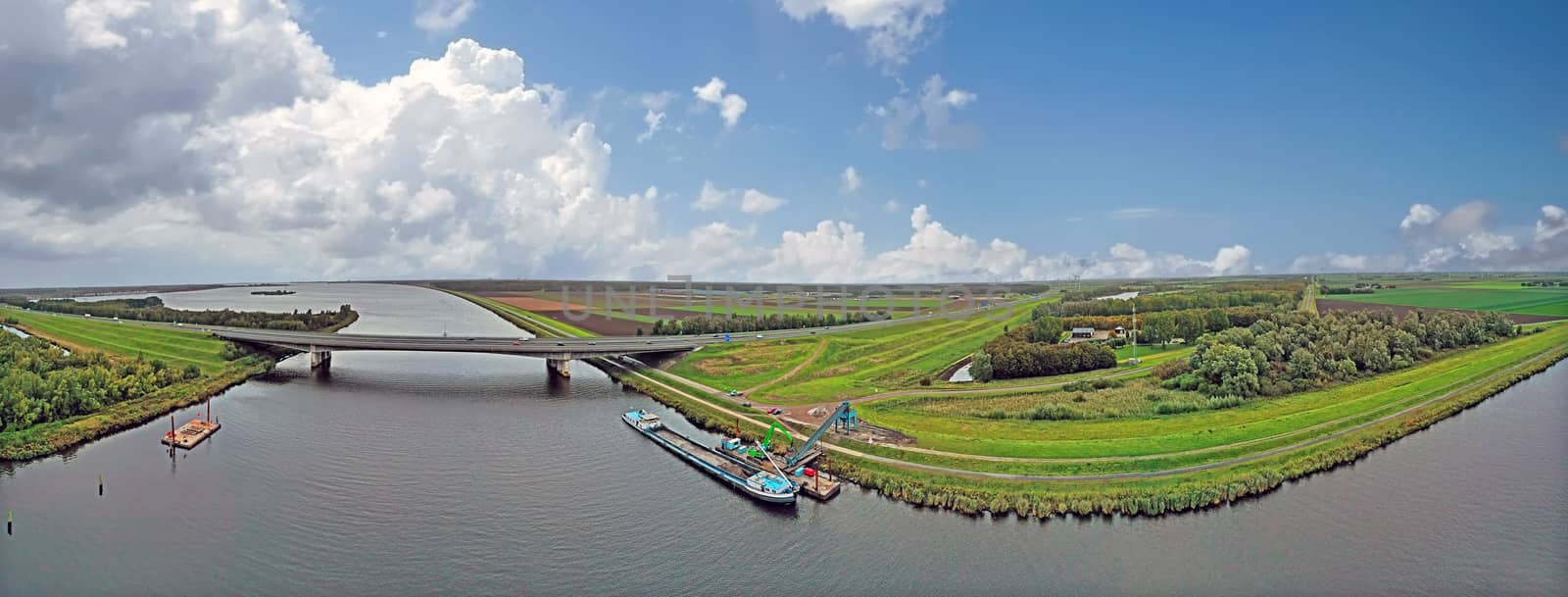Typical dutch panoramic scenery: Highway A1 and a freighter unlo by devy