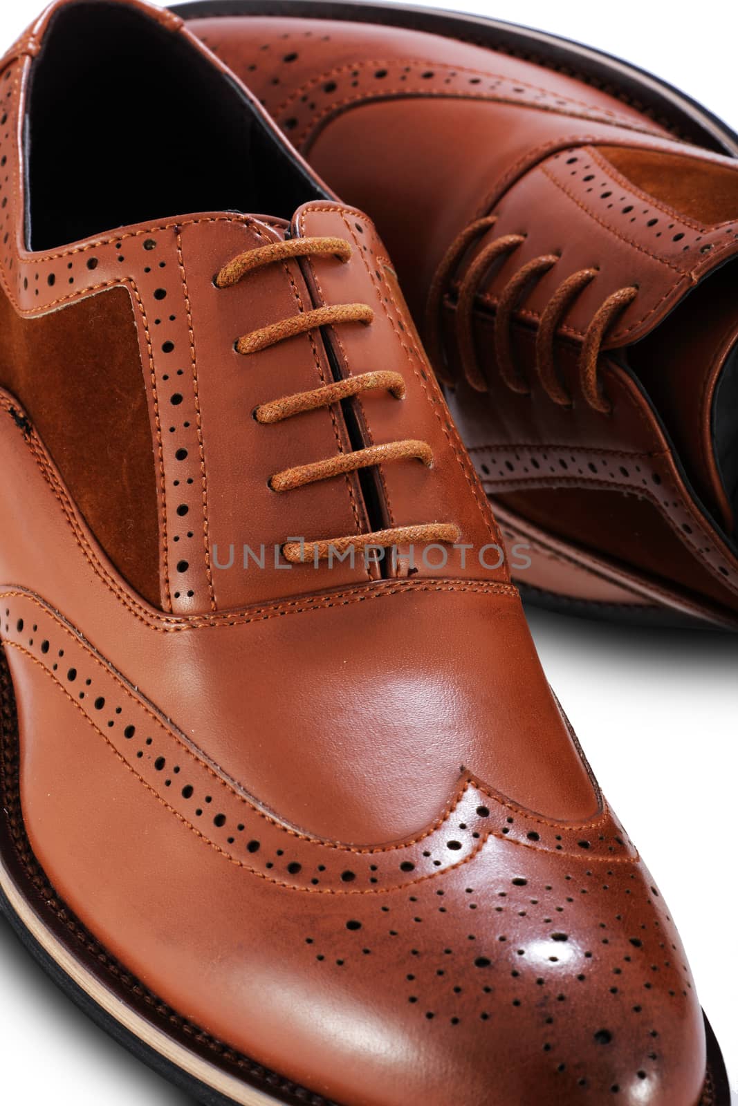 Men's brown brogue leather shoes on a white background