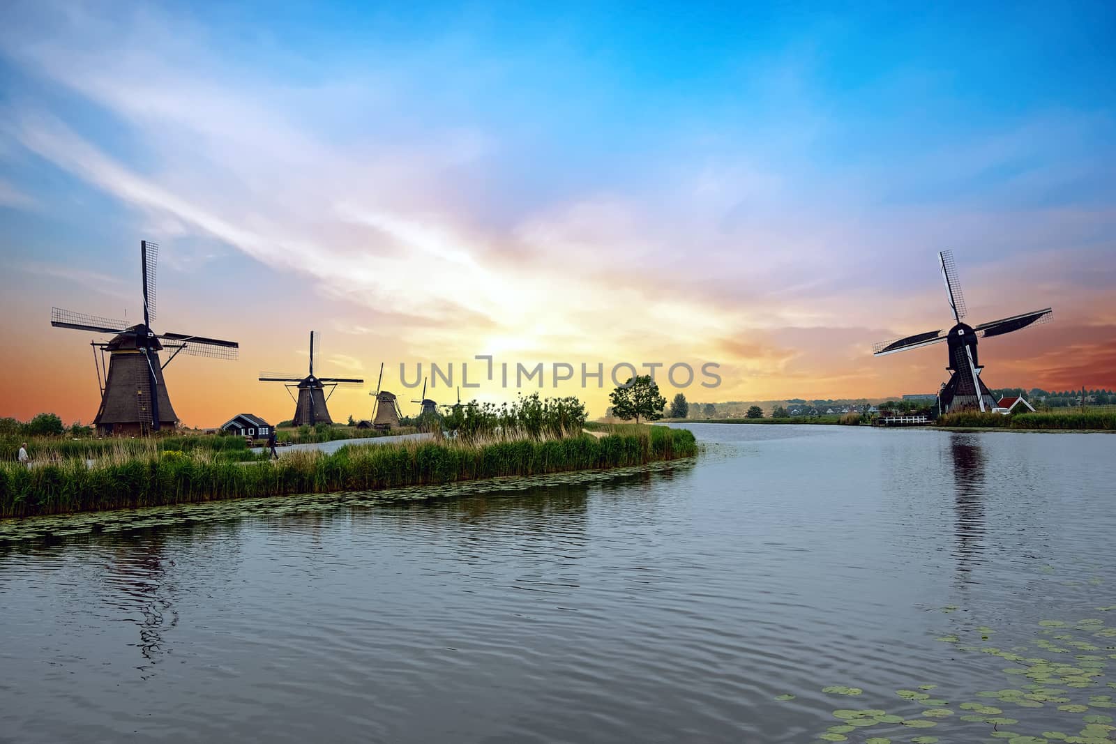 Traditional windmills at Kinderdijk in the Netherlands at sunset by devy