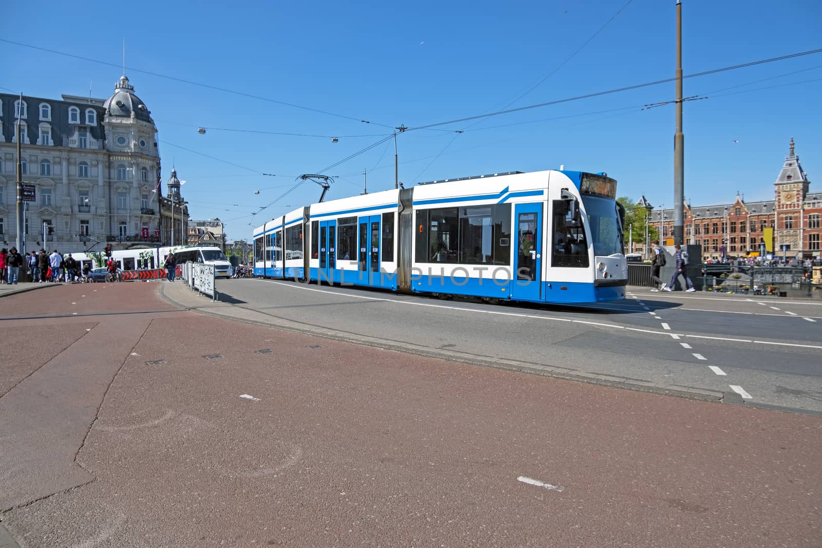 Tram driving in the city center from Amsterdam in the Netherlands with the central station