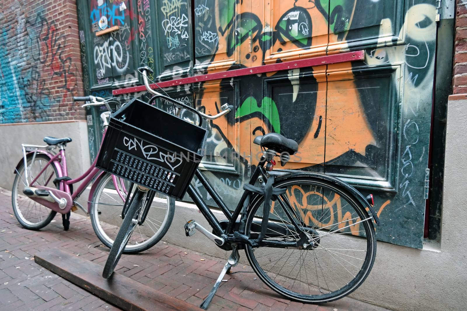 Dutch bikes against a grafitti wall in Amsterdam the Netherlands by devy