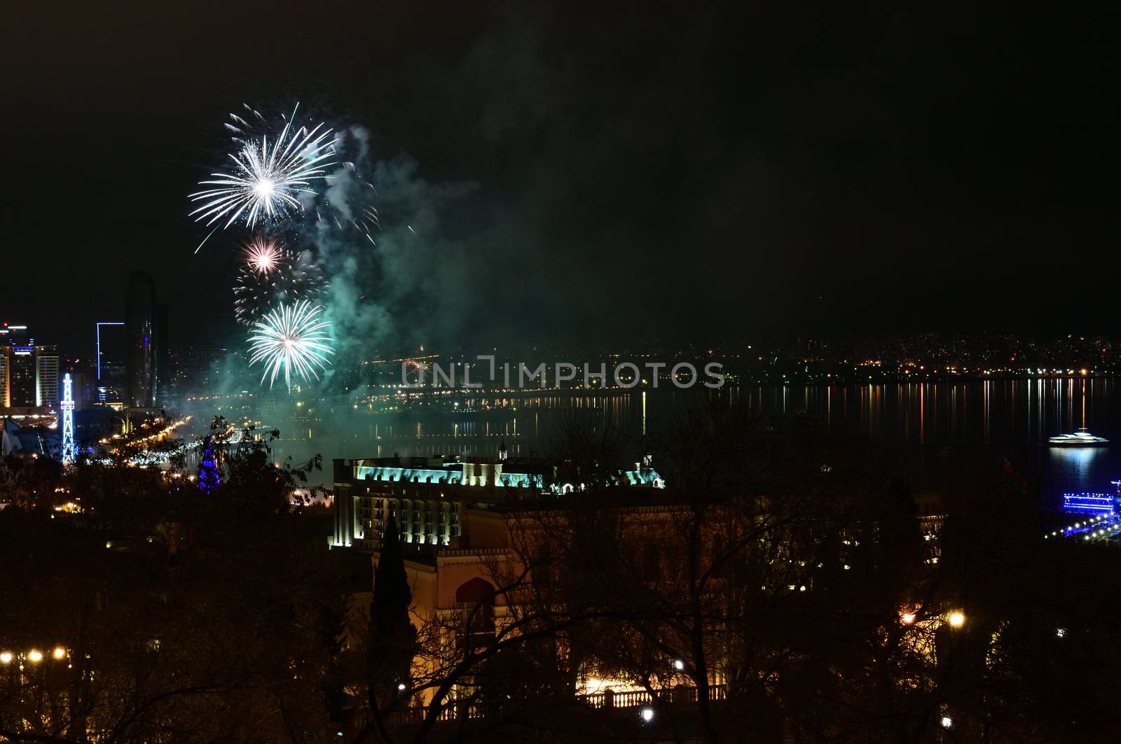 Colorful and various salutes and fireworks in the night city of Baku over the Caspian Sea.