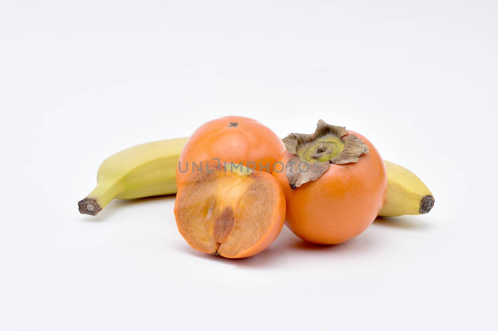 Persimmon,Banana on a white background.Natural.For Isolation. by moviephoto