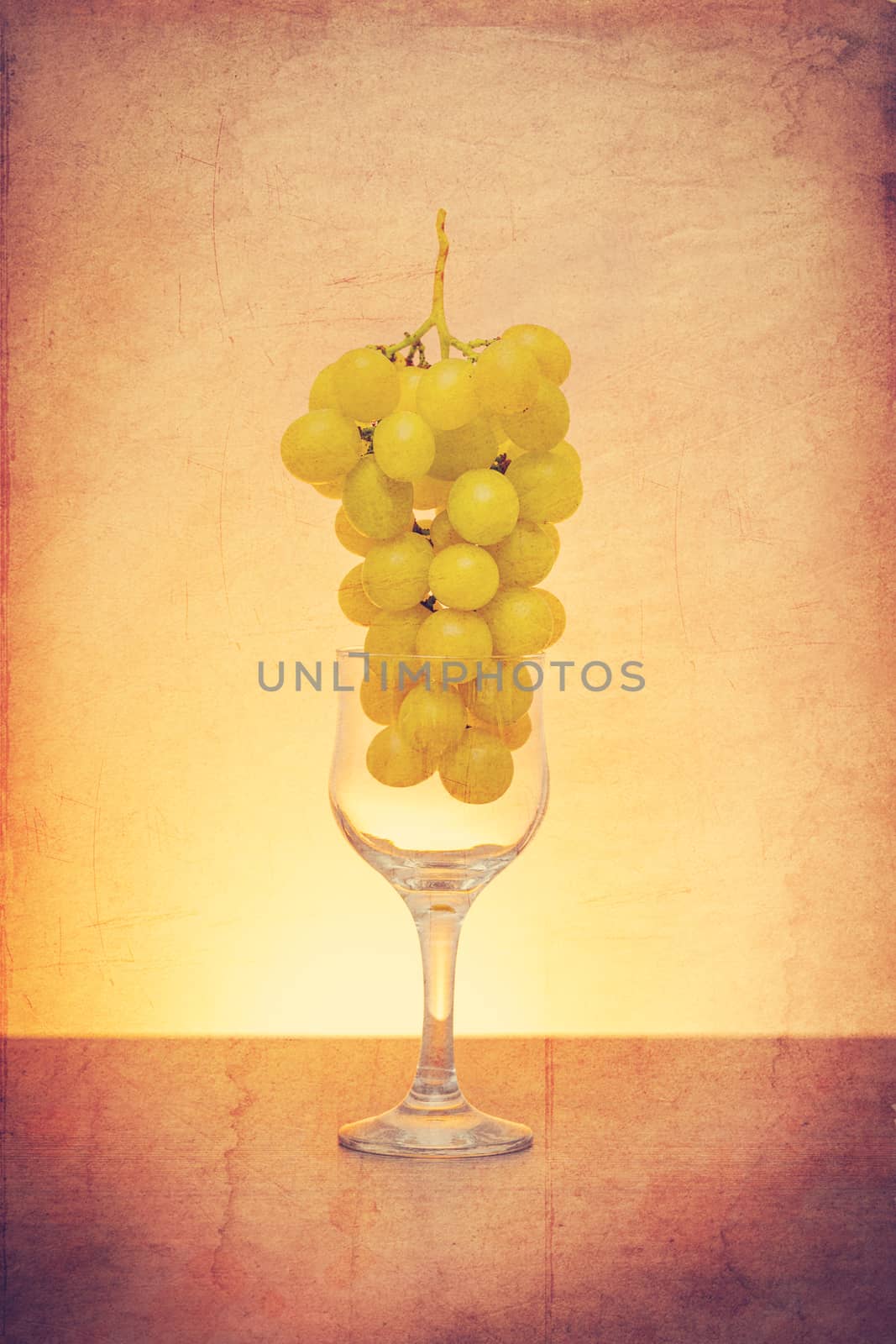 Grapes in wine glass concept by marugod83