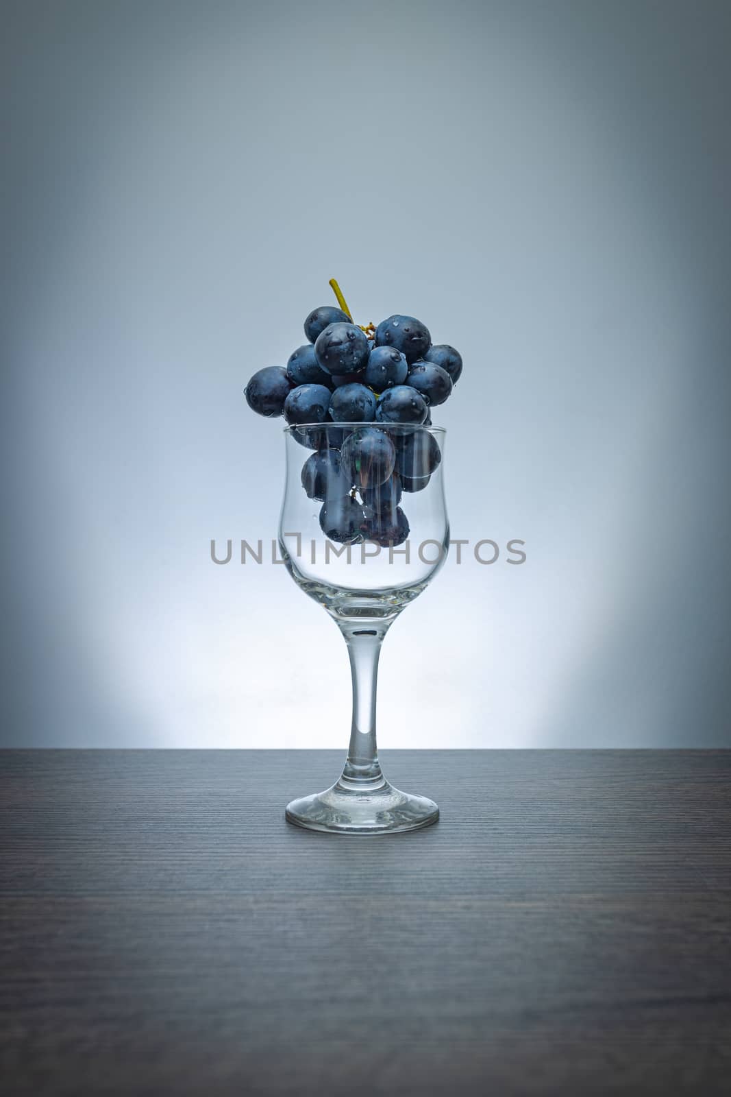 Grapes in wine glass concept by marugod83