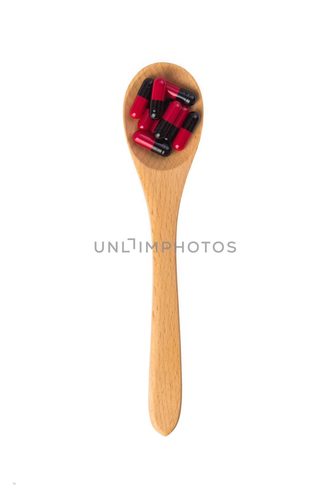  pills in wooden spoon by tehcheesiong