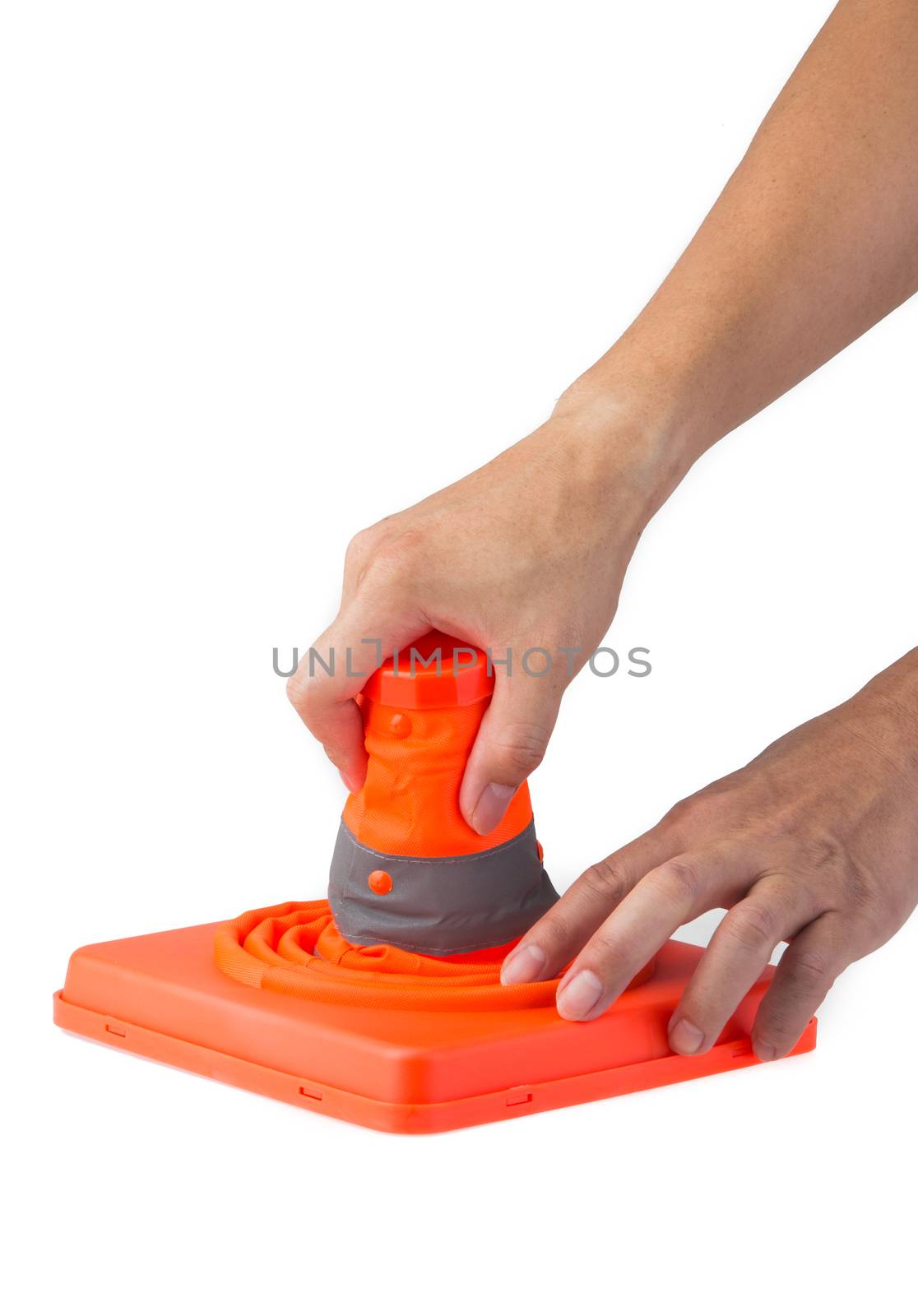 hand pulling up a foldable safety cone