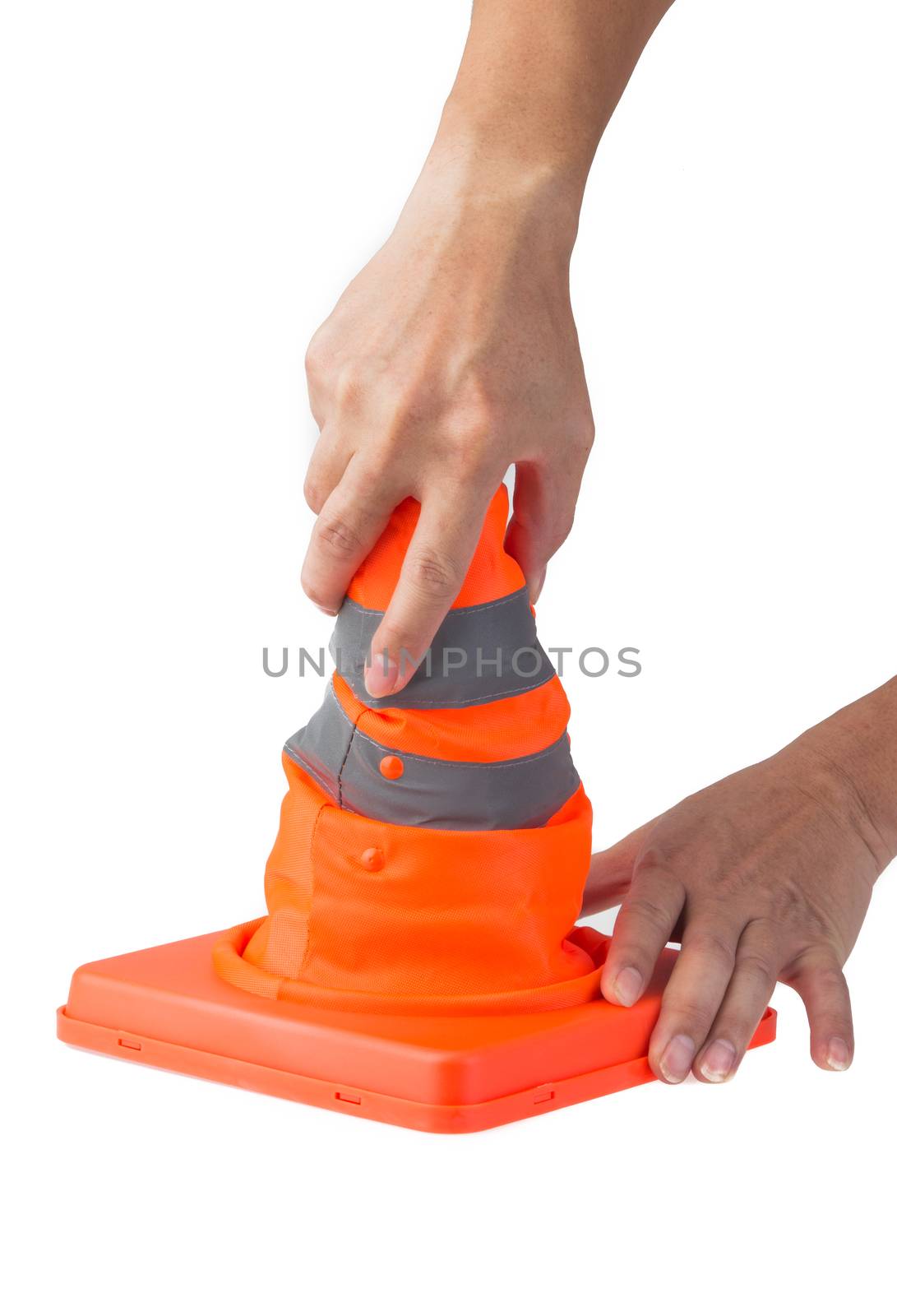 hand pulling up a foldable safety cone by tehcheesiong