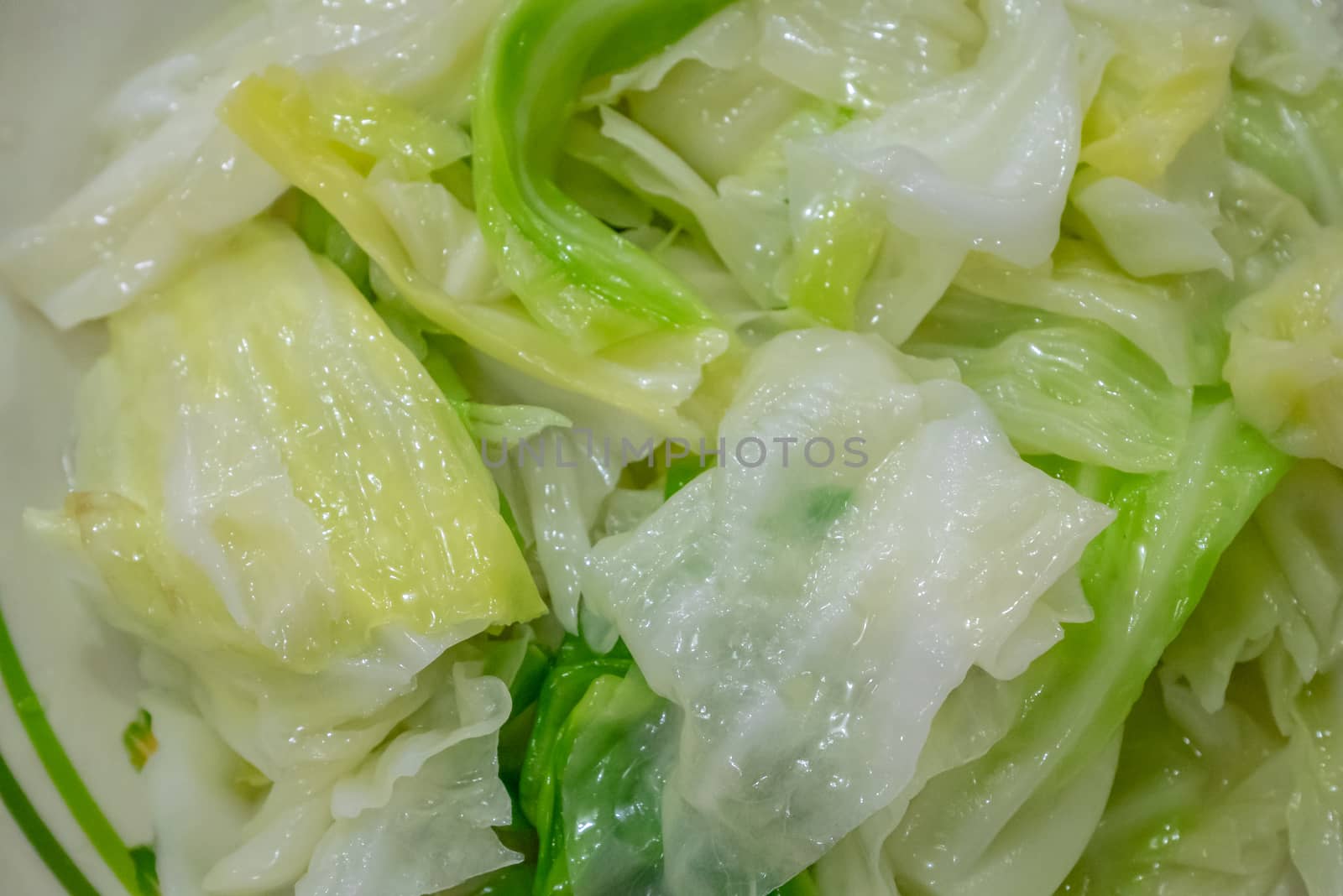 The close up of delicious stir fried cabbage on white plate at Taiwanese restaurant.