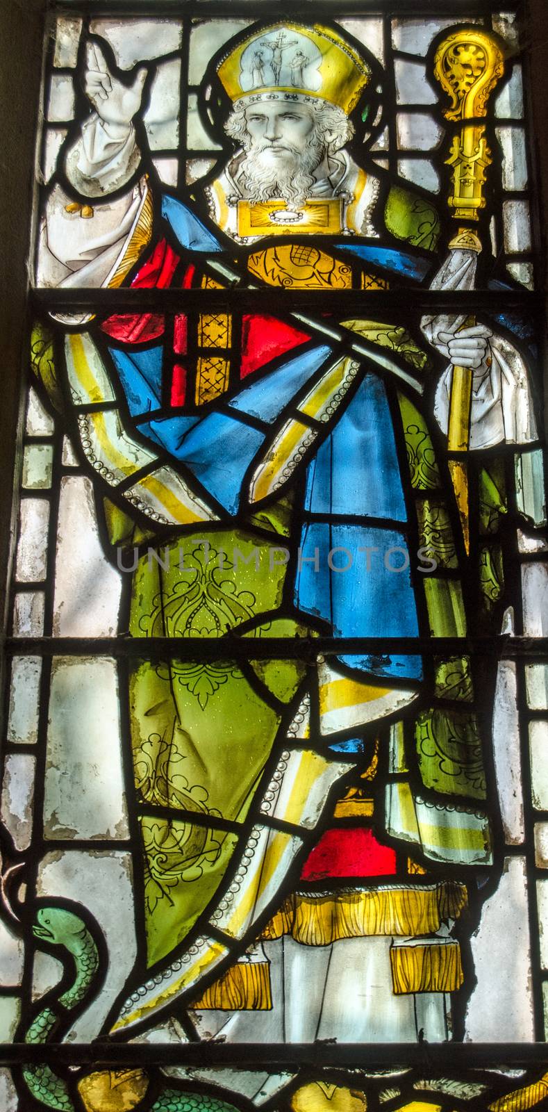 Victorian stained glass window depicting Saint Patrick, standing on one of the snakes he banished from Ireland.  On public display over 100 years.