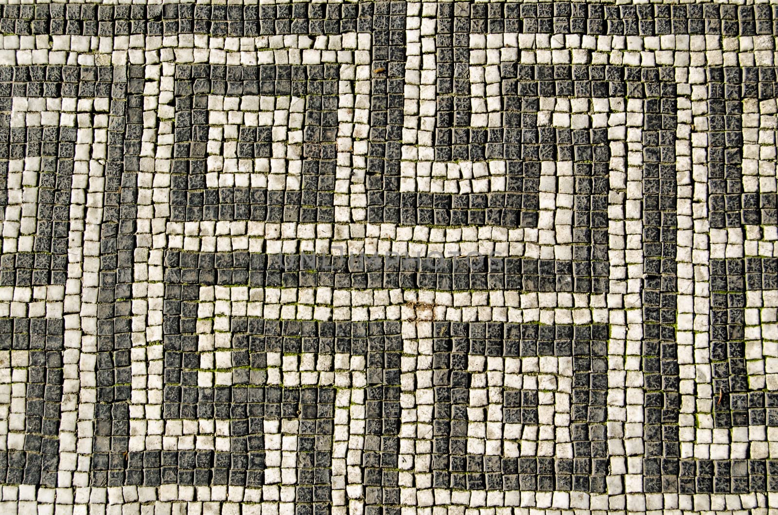 Mosaic tiles in the form of a greek key design on a pavement in London.  