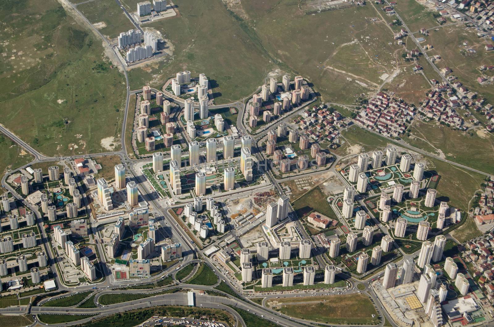 Aerial view of a new high-rise housing development with colourful blocks of flats built with swimming pools attached. Western suburbs of Istanbul, Turkey.